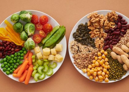 A vibrant flatlay of colorful vegetables and nuts showcasing a balanced diet concept.